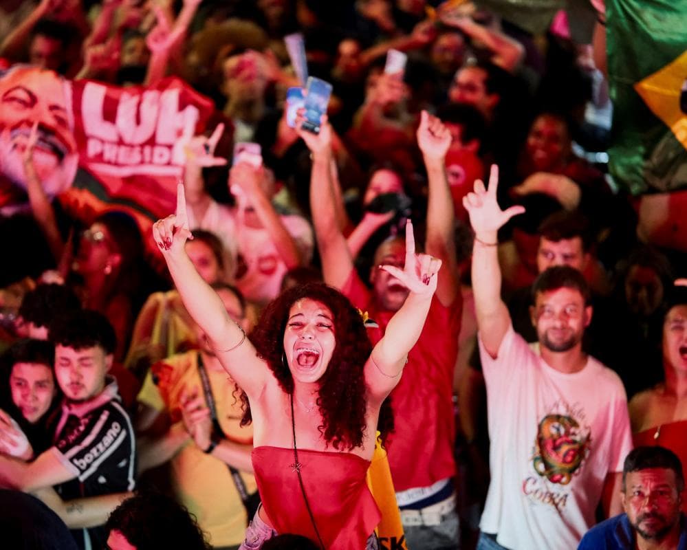Supporters of Brazilian President Luiz Inacio Lula da Silva, the Workers' Party (PT) candidate for presidential re-election, sign "L" as they celebrate Lula's victory 