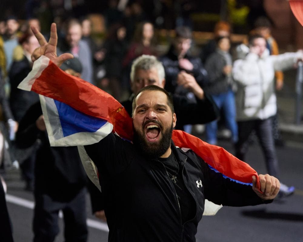 Supporters of the student movement celebrate in the streets of central Belgrade on Sunday night