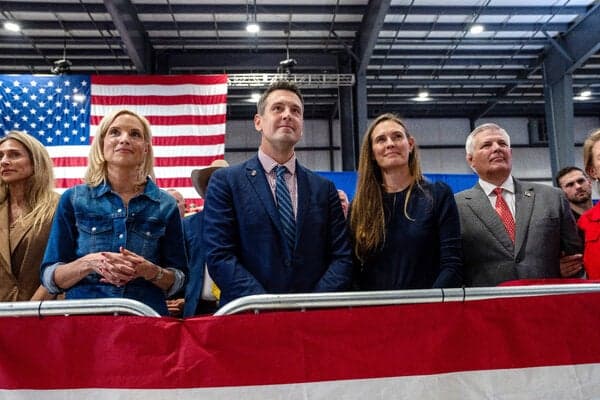 Zach Lahn, the Republican candidate for governor in Iowa, center, listens as President Trump speaks at a campaign rally in Sioux City last week.
